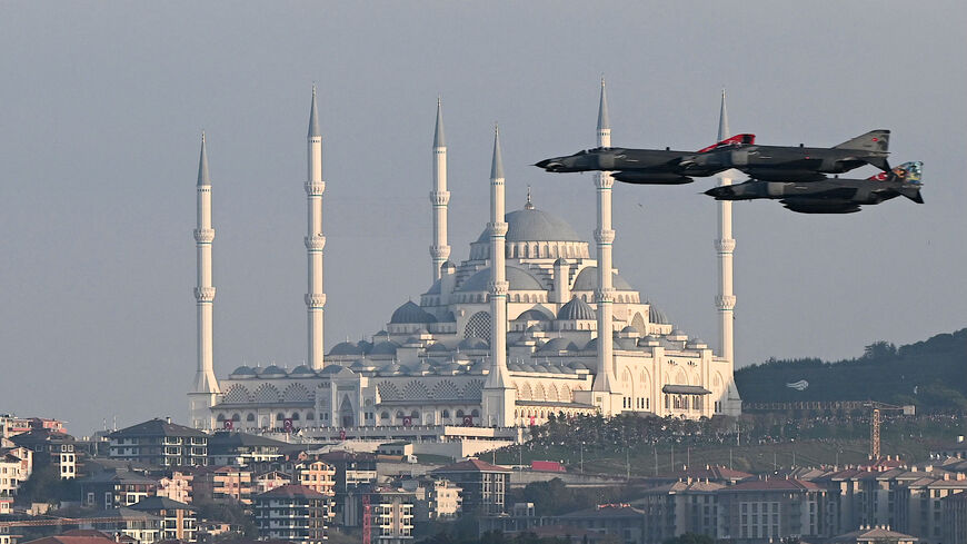 Turkish air force fighter jets perform a military parade over the Bosphorus as Camlica mosque is seen in the background to mark the 100th anniversary of Turkish Republic in Istanbul on Oct. 29, 2023. 