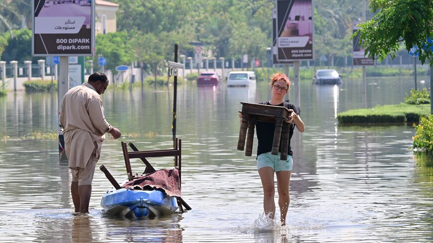 People salvage belongings after heavy flooding due to record rains in Dubai, April 19, 2024.
