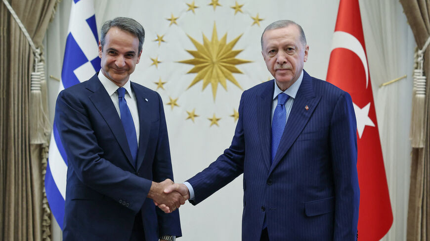 This handout photograph taken and released by the Turkish Presidency Press Service on May 13, 2024 shows Greek Prime Minister Kyriakos Mitsotakis (L) and Turkish President Recep Tayyip Erdogan posing before a meeting in Ankara. 