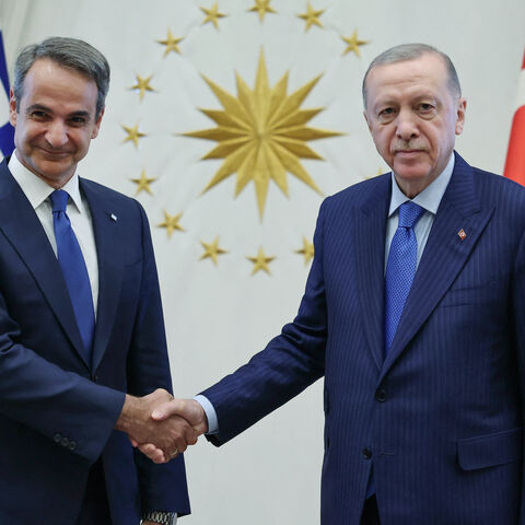 This handout photograph taken and released by the Turkish Presidency Press Service on May 13, 2024 shows Greek Prime Minister Kyriakos Mitsotakis (L) and Turkish President Recep Tayyip Erdogan posing before a meeting in Ankara. 