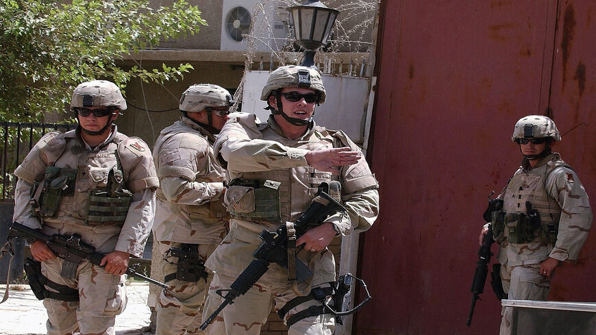 US soldiers patrol at the Egyptian Embassy in Baghdad, Iraq, July 8, 2005.