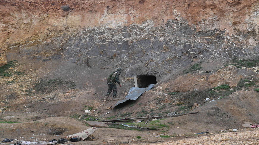 A Syrian army soldier inspects tunnels reportedly dug by rebel fighters in Tallet al Sakhr, near the Tallet al-Abyad area in Aleppo's southwestern countryside, during an ongoing pro-government offensive, Syria, Jan. 30, 2020.