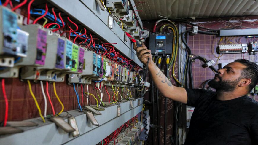 Iraqi Aqeel Hassan, part owner of private electric generators, is pictured on July 17, 2021, at his business in Baghdad's Sadr City district.