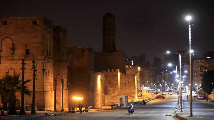 The street along the carved minaret of Al-Hakim Mosque is deserted on the first day of a two-week night-time curfew imposed by the authorities to contain the spread of the coronavirus, Cairo, Egypt, March 25, 2020.