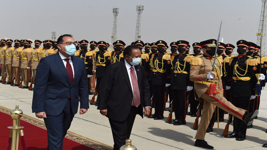 Egyptian Prime Minister Mustafa Madbouly (L) welcomes his Sudanese counterpart Abdalla Hamdok upon his arrival in Cairo, Egypt, March 11, 2021.