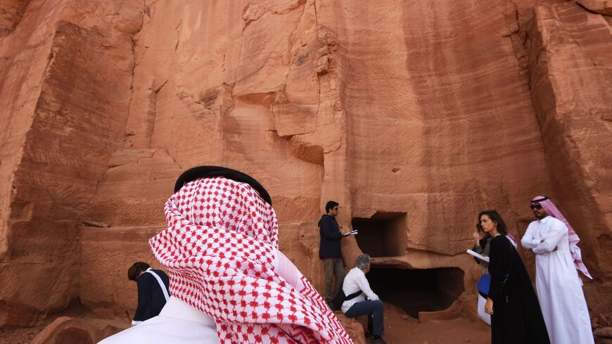 A picture taken on March 31, 2018 shows a Saudi man standing at the entrance of a tomb at Madain Saleh, a UNESCO World Heritage site, near Saudi Arabia's northwestern town of al-Ula. - Al-Ula, an area rich in archaeological remnants, is seen as a jewel in the crown of future Saudi attractions as the austere kingdom prepares to issue tourist visas for the first time -- opening up one of the last frontiers of global tourism. Saudi Crown Prince Mohammed bin Salman is set to sign a landmark agreement with Paris
