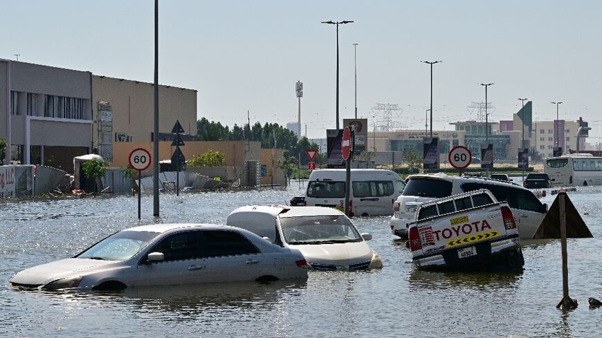 Waterlogged vehicles await recovery on a flooded Dubai highway