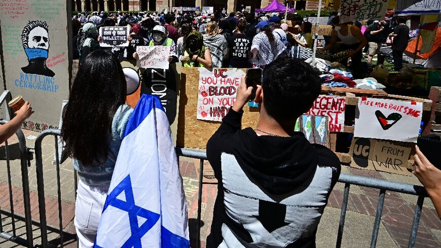 Pro-Israel (front) and pro-Palestinian students face off at an encampment on the campus of the University of California Los Angeles 