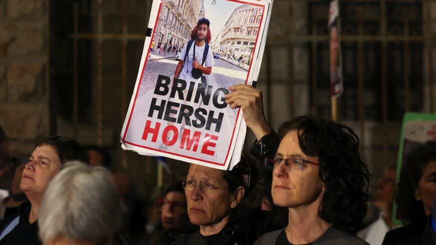 Demonstrators raise a poster of Hersh Goldberg-Polin at a rally this week in Jerusalem urging action to rescue hostages remaining in Gaza