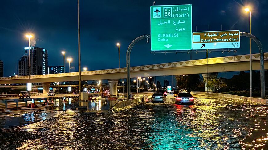 Motorists drive along a flooded street following heavy rains in Dubai early on April 17, 2024. 