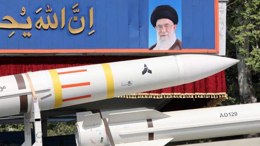 An Iranian military truck carries a Sayad 4-B missile past a portrait of supreme leader Ayatollah Ali Khamenei during a military parade on April 17, 2024