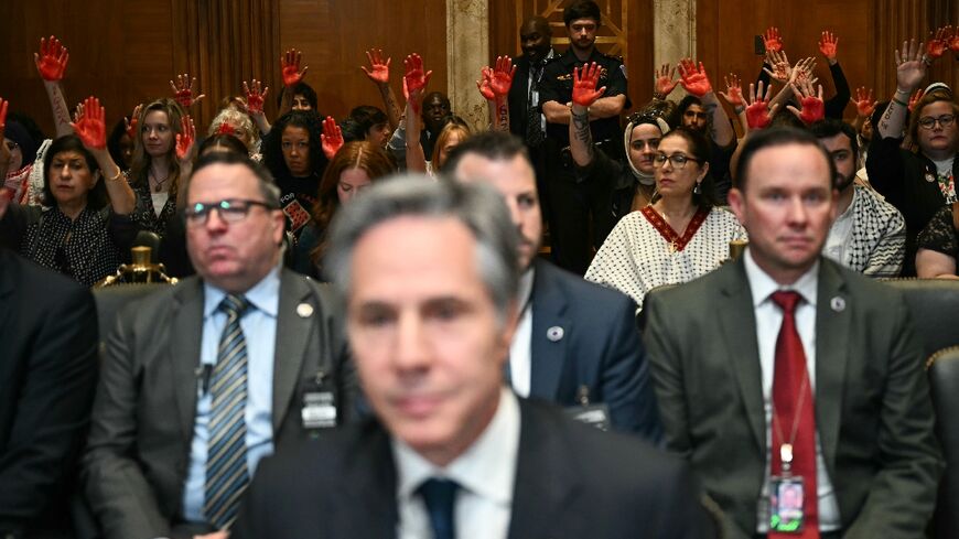 Pro-Palestinian demonstrators hold up painted hands in protest as US Secretary of State Antony Blinken testifies before a Senate Appropriations subcommittee 