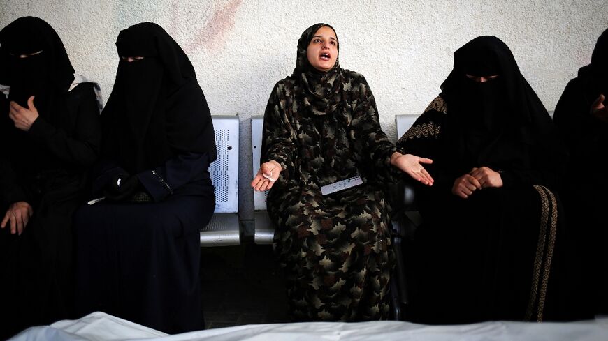 Sanaa Zoorob, centre, mourns at Al-Najjar Hospital, Rafah, her sister and the sister's six children killed in a strike on their home