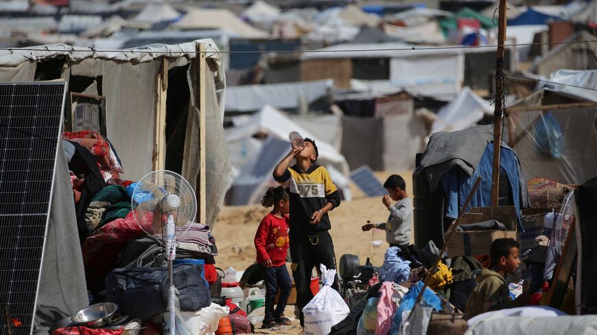 Displaced Palestinians gather their belongings before fleeing al-Mawasi to a safer area in Rafah in the southern Gaza Strip on May 9, 2024, amid the ongoing conflict between Israel and militants from the Hamas movement. 
