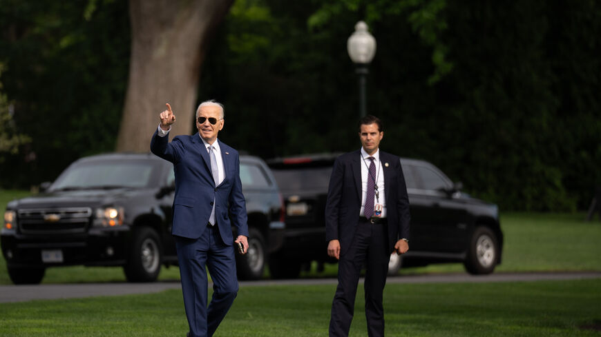 WASHINGTON, DC - MAY 9: U.S. President Joe Biden points to WNBA Champion Las Vegas Aces players and other invited guests as he walks towards Marine One on the South Lawn of the White House on May 9, 2024 in Washington, DC, for a short trip to Andrews Air Force Base, Md. Biden is traveling to San Francisco, California for campaign fundraisers. (Photo by Andrew Harnik/Getty Images)