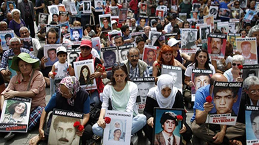 Turkish Kurdish people hold pictures of their relatives who were killed in clashes between Kurdistan Workers' Party (PKK) guerrillas and Turkish security forces, during a demonstration in central Istanbul June 8, 2013. More than 40,000 people have been killed in the separatist conflict in southeast Turkey since the Kurdistan Workers Party (PKK) took up arms against the state in 1984.   REUTERS/Stoyan Nenov (TURKEY - Tags: POLITICS CIVIL UNREST) - RTX10G9A
