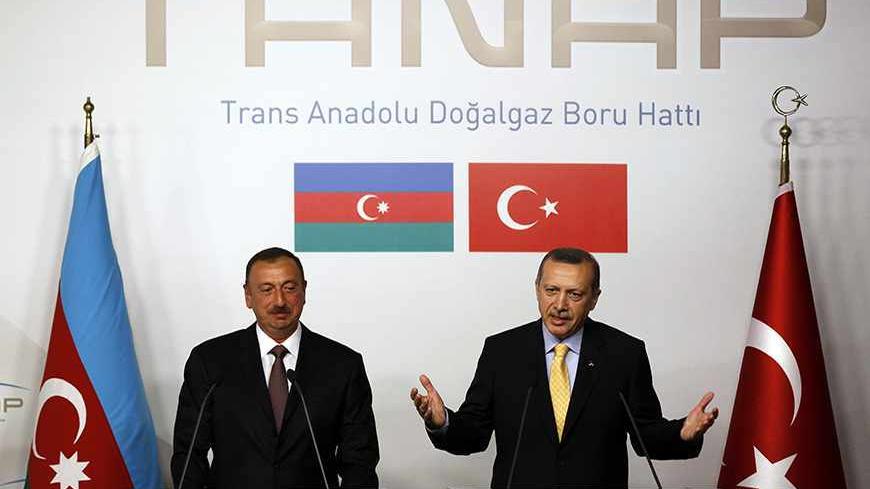 Turkey's Prime Minister Tayyip Erdogan (R) speaks as Azerbaijan's President Ilham Aliyev listens during a news conference following a signing ceremony in Istanbul June 26, 2012. Turkey and Azerbaijan signed an inter-governmental agreement on Tuesday on the $7 billion Trans-Anatolian natural gas pipeline project (TANAP), planned to carry Azeri natural gas across Turkey to Europe. Turkish Prime Minister Tayyip Erdogan and Azeri President Ilham Aliyev signed the deal at an Istanbul ceremony to launch a project
