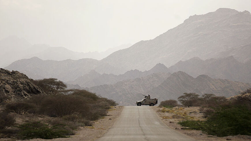 An army vehicle patrols in al-Mahfad of the southern Yemeni province of Abyan May 23, 2014. Yemeni forces have faced a wave of hit-and-run attacks by al Qaeda insurgents since the army captured their strongholds in al-Mahfad in Abyan province and in Mayfa'a, Azzan and Gol al-Rayda in Shabwa province earlier this month. Picture taken May 23, 2014. REUTERS/Khaled Abdullah (YEMEN - Tags: POLITICS MILITARY CIVIL UNREST TPX IMAGES OF THE DAY) - RTR3QMO6
