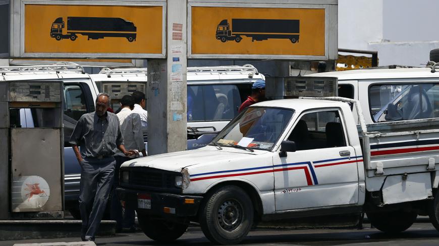 People wait to buy fuel at a petrol station in Cairo July 6, 2014. Egypt's Prime Minister Ibrahim Mehleb has sought to justify politically sensitive subsidy cuts on fuel and natural gas which took effect on Saturday, saying they were a necessary part of fixing an economy hammered by three years of turmoil. Egypt had overnight on Friday slashed its subsidies for car fuel and natural gas, increasing their prices by more than 70 percent. REUTERS/Amr Abdallah Dalsh  (EGYPT - Tags: POLITICS BUSINESS ENERGY TRANS