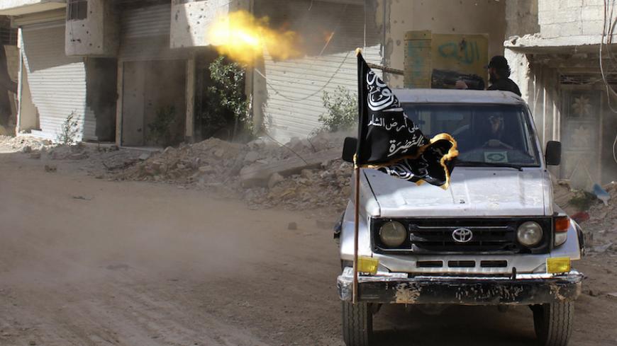 A member of the Islamist Syrian rebel group Jabhat al-Nusra fires during clashes with Syrian forces in eastern al-Ghouta, near Damascus April 8, 2014. Picture taken April 8, 2014.  REUTERS/Ammar Al-Bushy  ( SYRIA - Tags: POLITICS CIVIL UNREST CONFLICT) - RTR3KIUC