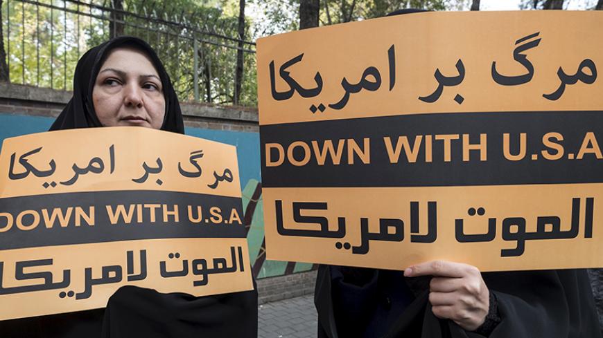 Women hold anti-U.S. banners during a demonstration outside the former U.S. embassy in Tehran November 4, 2015. REUTERS/Raheb Homavandi/TIMA ATTENTION EDITORS - THIS IMAGE WAS PROVIDED BY A THIRD PARTY. FOR EDITORIAL USE ONLY. - RTX1UOX7