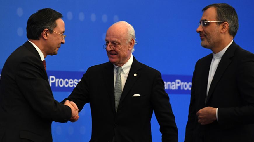 UN Syria envoy Staffan de Mistura (C) shakes hands with Kazakh Foreign Minister Kairat Abdrakhmanov (L) as Iran's Deputy Foreign Minister Hossein Jaber Ansari stands beside during the announcement of a final statement following Syria peace talks in Astana on January 24, 2017. / AFP / Kirill KUDRYAVTSEV        (Photo credit should read KIRILL KUDRYAVTSEV/AFP/Getty Images)
