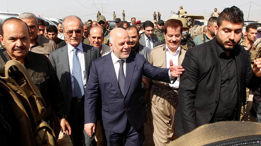 Iraqi Prime Minister Haider al-Abadi (C) gestures during his visit in Kirkuk, Iraq, October 14, 2016. REUTERS/Ako Rasheed - RTSSANO
