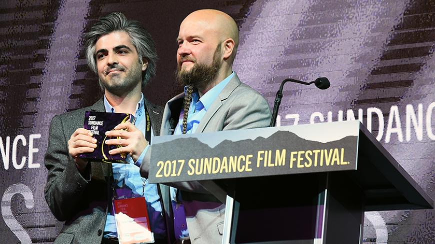 PARK CITY, UT - JANUARY 28:  Steen Johannessen and Feras Fayyad accept the World Cinema: Grand Jury Prize for their film "Last Men in Aleppo" during the 2017 Sundance Film Festival Awards Night Ceremony at Basin Recreation Field House on January 28, 2017 in Park City, Utah.  (Photo by Nicholas Hunt/Getty Images for Sundance Film Festival)