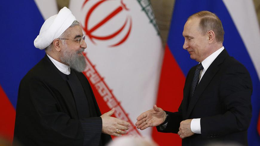 Russian President Vladimir Putin shakes hands with Iranian President Hassan Rouhani during a joint news conference following their meeting at the Kremlin in Moscow, Russia March 28, 2017. REUTERS/Sergei Karpukhin - RTX332WO