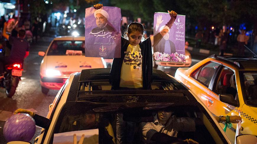 A girl holds posters of Iranian President Hassan Rouhani during a campaign rally in Tehran, Iran, May 17, 2017. Picture taken  May 17, 2017. TIMA via REUTERS ATTENTION EDITORS - THIS IMAGE WAS PROVIDED BY A THIRD PARTY. FOR EDITORIAL USE ONLY. - RTX36BFD