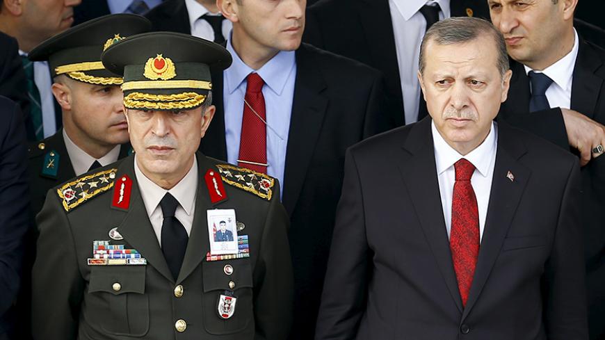 Turkish President Tayyip Erdogan (R) and Chief of Staff General Hulusi Akar attend a funeral ceremony for Army officer Seckin Cil in Ankara, Turkey, February 18, 2016. Army officer Cil was killed during the clashes between Turkish security forces and Kurdish militants in Sur district of the southeastern city of Diyarbakir. REUTERS/Umit Bektas - RTX27IP3