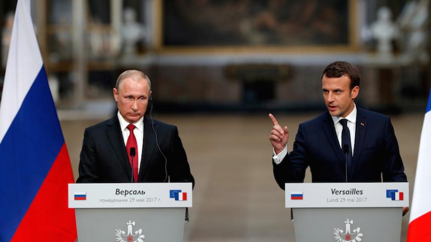 French President Emmanuel Macron (R) and Russian President Vladimir Putin (L) give a joint press conference at the Chateau de Versailles before the opening of an exhibition marking 300 years of diplomatic ties between the two countries in Versailles, France, May 29, 2017.   REUTERS/Philippe Wojazer     TPX IMAGES OF THE DAY - RTX385T3