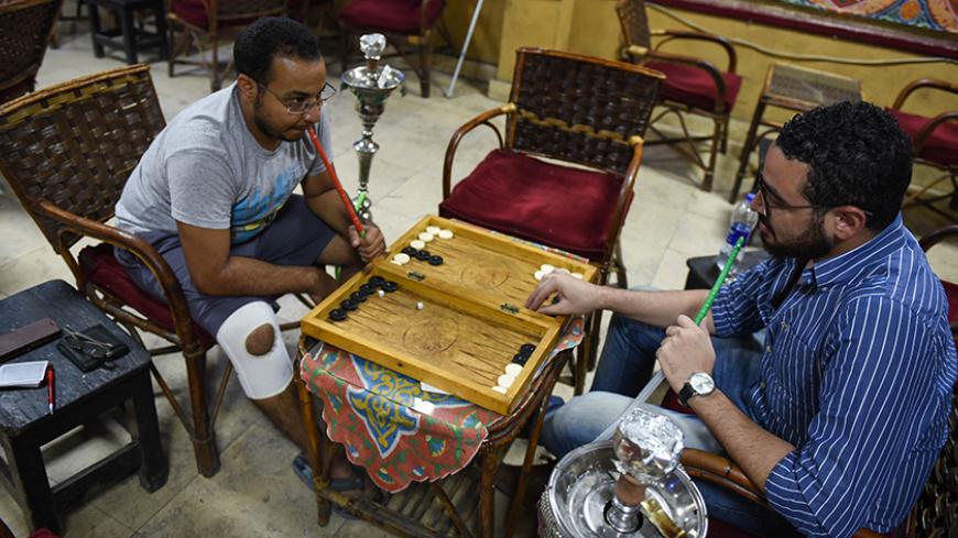 Unemployed Egyptian men play backgammon at a cafe in the capital Cairo on October 8, 2015. North Africa and Middle East regions still have the highest unemployment rate in the world, according to a World Trade Organization (WTO) report published on October 8, 2015. AFP PHOTO  / MOHAMED EL-SHAHED        (Photo credit should read MOHAMED EL-SHAHED/AFP/Getty Images)
