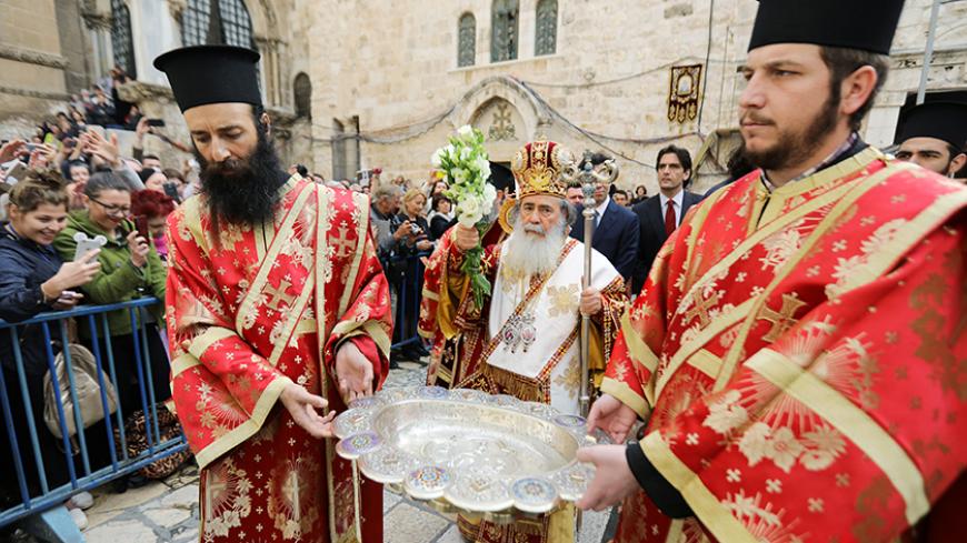 Greek Orthodox Patriarch of Jerusalem Theophilos III (C) leads the Orthodox Christian "Washing of the Feet" ceremony outside the Church of the Holy Sepulchre in Jerusalem's Old City April 13, 2017. REUTERS/Ammar Awad - RTX35CPS