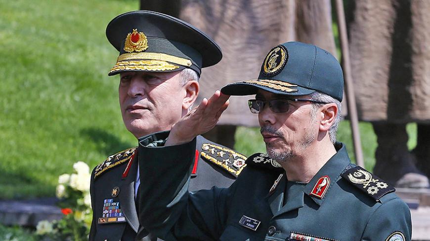 General Staff of the Armed Forces of Iran, Mohammad Bagheri (R) salutes the honor guards as he is welcomed by Chief of the General Staff of the Turkish Armed Forces Hulusi Akar (L) during his official visit at the Turkish General Staff headquarters in Ankara, on August 15, 2017.   / AFP PHOTO / STR        (Photo credit should read STR/AFP/Getty Images)