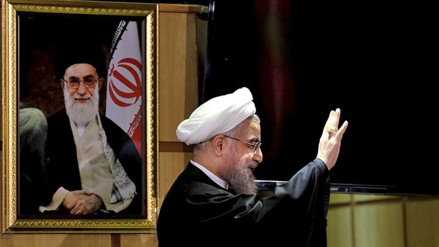Iranian President Hassan Rouhani waves as he stands next to a portrait of Iran's Supreme Leader Ayatollah Ali Khamenei, after he registered for February's election of the Assembly of Experts, the clerical body that chooses the supreme leader, at Interior Ministry in Tehran December 21, 2015. REUTERS/Raheb Homavandi/TIMA ATTENTION EDITORS - THIS IMAGE WAS PROVIDED BY A THIRD PARTY. FOR EDITORIAL USE ONLY. TPX IMAGES OF THE DAY     - RTX1ZKHQ