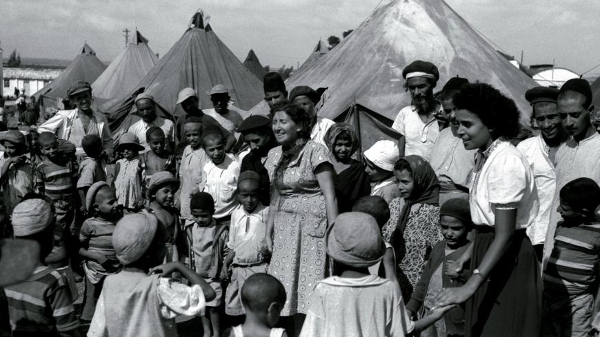 FILE PHOTO 1OCT49 - Jewish immigrants from Yemen in a tent encampment in 1949 as they are visited by Israeli nurses. Many Jewish immigrants of Sephardic origin from North Africa and the Middle East were shipped to Israeli development town when they arrived, while many of the European, or Ashkenazi, immigrants were able to start their new lives in Israel's cities with promising jobs. Most of the Yemenites arrived in Israel during "Operation Magic Carpet" in the late 1940's. In the 1950's and 60's some 300,00
