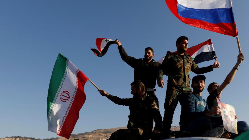 Syrians wave Iranian, Russian and Syrian flags during a protest against U.S.-led air strikes in Damascus,Syria April 14,2018.REUTERS/ Omar Sanadiki - RC151A9ED3D0