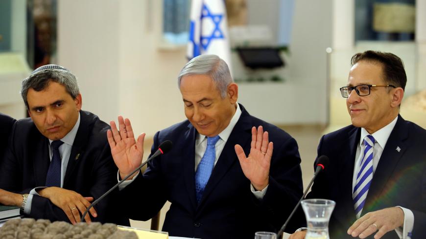 Israeli Prime Minister Benjamin Netanyahu (C), Minister of Jerusalem and Environmental Protection Zeev Elkin (L) and Cabinet Secretary Tzachi Braverman (R) attend a special cabinet meeting marking Jerusalem Day, at the Bible Lands Museum in Jerusalem May 13, 2018. REUTERS/Amir Cohen/Pool - RC1396C81E50