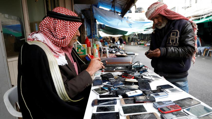 A Palestinian man sells used mobile phones in the West Bank city of Ramallah January 24, 2018. REUTERS/Mohamad Torokman - RC11656AA640