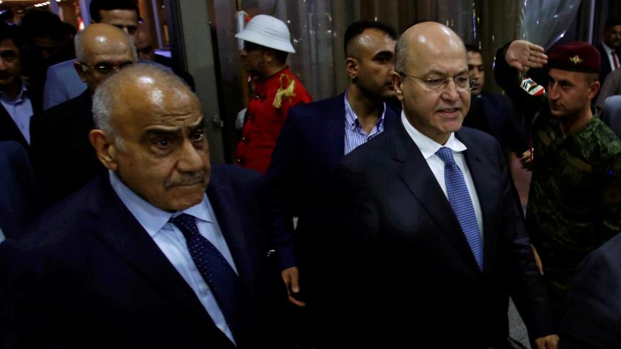 Barham Salih, Iraq's newly elected president, walks with Iraq's new Prime Minister Adel Abdul Mahdi at the parliament headquarters, in Baghdad, Iraq October 2, 2018. REUTERS/Khalid al Mousily - RC14461FCEC0