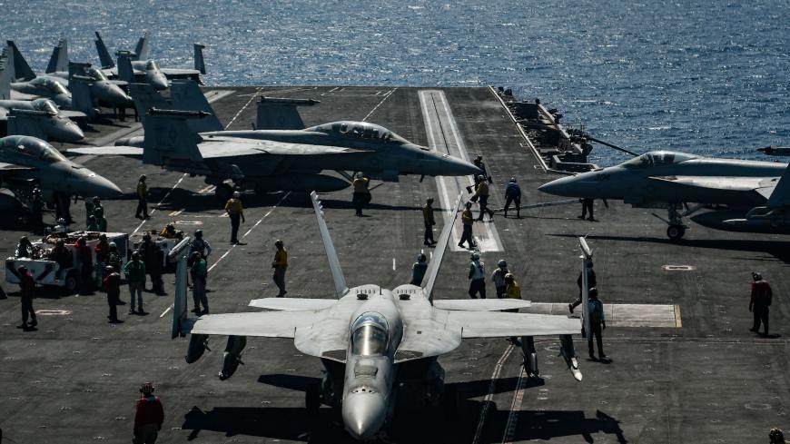An F18 Hornet fighter jet moves on the deck of the 330 meters navy aircraft carrier USS Harry S. Truman in the eastern Mediterranean Sea on May 8, 2018. - The USS Harry S. Truman Carrier Strike Group on May 3 began air operations in support of Operation Inherent Resolve, conducting flight operations against the so called Islamic State (IS) targets in Syria and Iraq. The strike group includes a guided-missile cruiser and four guided-missile destroyers. (Photo by Aris MESSINIS / AFP)        (Photo credit shou