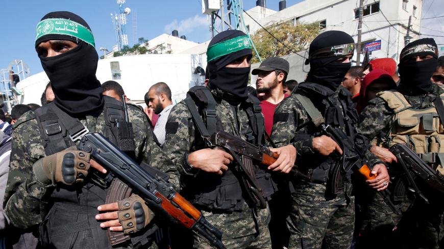 Palestinian militants of the Islamist movement Hamas' military wing Al-Qassam Brigades, attend the funeral of seven Palestinians, killed during an Israeli special forces operation in the Gaza Strip, on November 12, 2018, in Khan Younis. - A clash that erupted during an Israeli special forces operation in the Gaza Strip and killed eight people threatened on Monday to derail efforts to restore calm to the Palestinian enclave after months of unrest. (Photo by SAID KHATIB / AFP)        (Photo credit should read