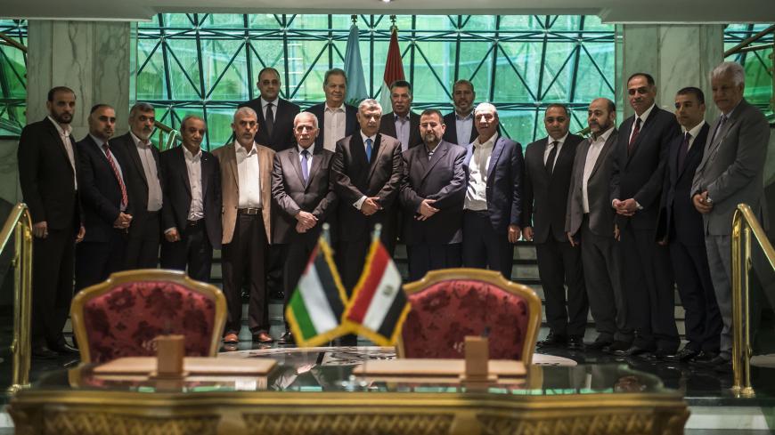 Khaled Fawzi (C), head of the Egyptian Intelligence services, Azzam al-Ahmad (C-L), head of the Fatah delegation for the talks, and Hamas' new deputy leader Salah al-Aruri (C-R) pose for a group picture with both Palestinian delegations following the signing of a reconciliation deal in Cairo on October 12, 2017, as the two rival Palestinian movements ended their decade-long split following negotiations overseen by Egypt.
The new Hamas deputy leader and the head of Fatah's delegation struck the deal which wa