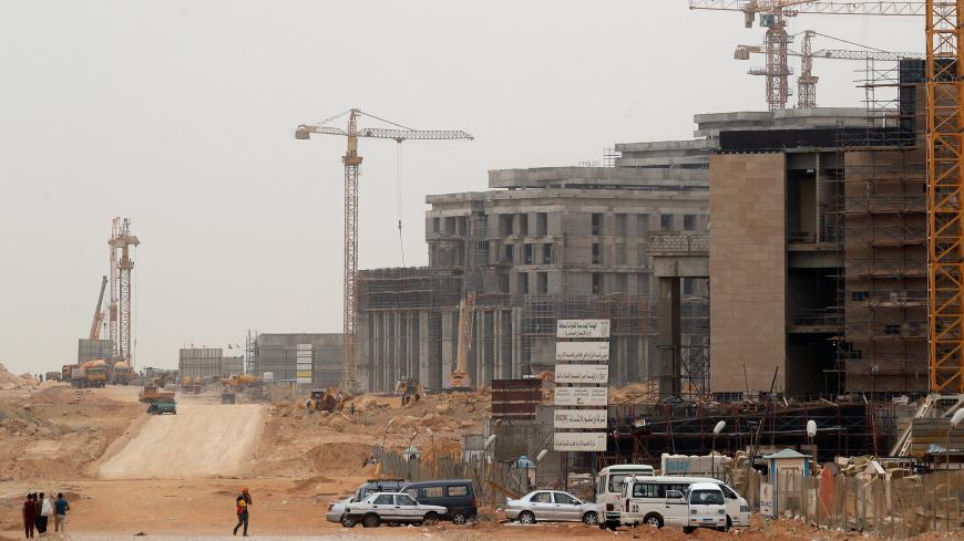 Construction machines and labourers work at the future headquarters of the Council of Ministers in the government district of the New Administrative Capital (NAC) east of Cairo, Egypt May 2, 2019. Picture taken May 2, 2019. REUTERS/Amr Abdallah Dalsh - RC1F74A68FD0