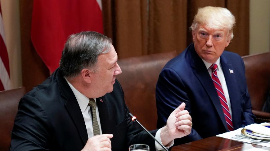 U.S. President Donald Trump listens to U.S. Secretary of State Mike Pompeo during a  lunch meeting with Poland's President Andrzej Duda in the Cabinet Room of the White House in Washington, U.S., June 12, 2019. REUTERS/Kevin Lamarque - RC120F191060