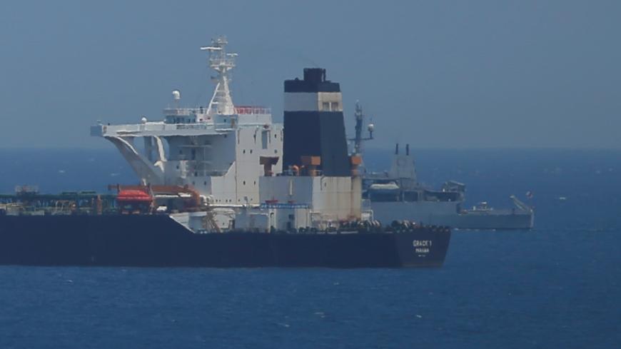 A British Royal Navy patrol vessel guards the oil supertanker Grace 1, that's on suspicion of carrying Iranian crude oil to Syria, as it sits anchored in waters of the British overseas territory of Gibraltar, historically claimed by Spain, July 4, 2019. REUTERS/Jon Nazca - RC1F65D414F0
