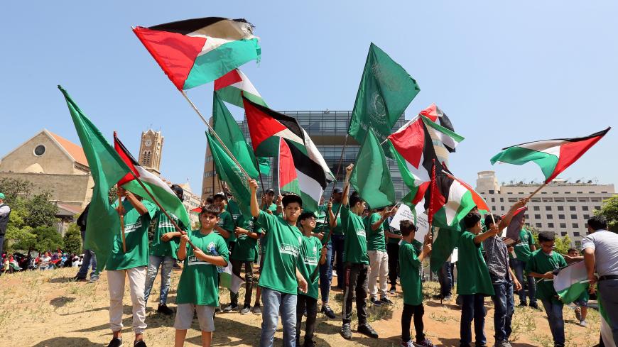 Demonstrators hold Palestinian flags as they take part in a protest against Bahrain's conference about U.S. President Donald Trump's vision for Mideast peace plan, in front of the U.N. headquarters, in Beirut, Lebanon, June 25, 2019. REUTERS/Aziz Taher - RC13E44861E0