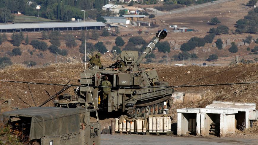 Israeli soldiers and armoured vehicles are pictured on November 19, 2019 near the border with Syria in the annexed Golan Heights. - Israel's anti-missile defence system intercepted four rockets fired from neighbouring Syria on Tuesday, the army said. "Four launches were identified from Syria towards Israeli territory which were intercepted by the Israeli air defense systems," the Israeli army said in a statement. (Photo by JALAA MAREY / AFP) (Photo by JALAA MAREY/AFP via Getty Images)