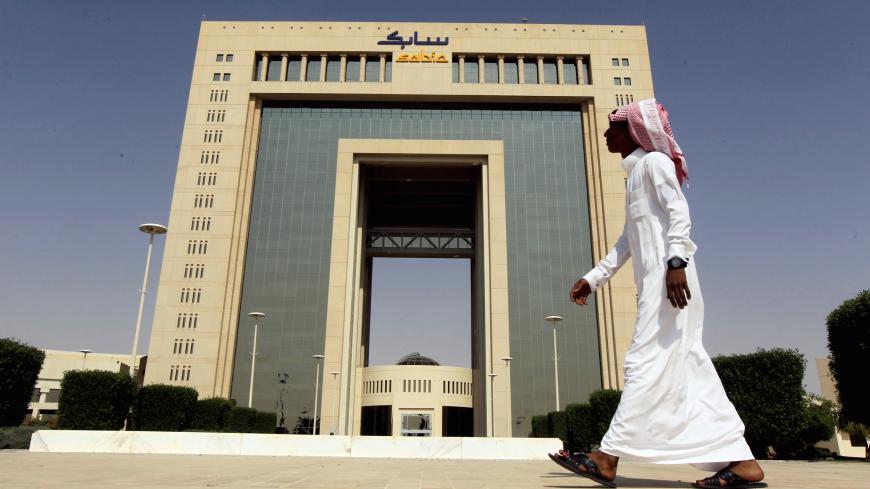 A man walks past the headquarters of Saudi Basic Industries Corp (SABIC) in Riyadh, Saudi Arabia October 27, 2013. REUTERS/Faisal Al Nasser/File Photo     TPX IMAGES OF THE DAY      - S1BETCCGREAA